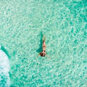 Young Woman Floating In The Caribbean Sea In Mexico